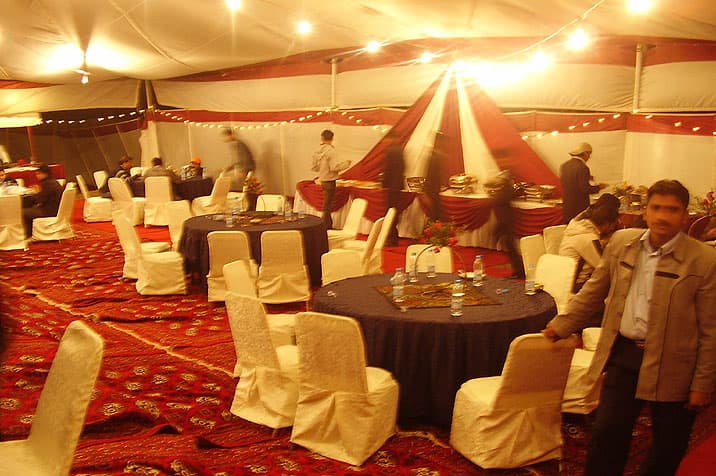 Dinner setup inside an event tent